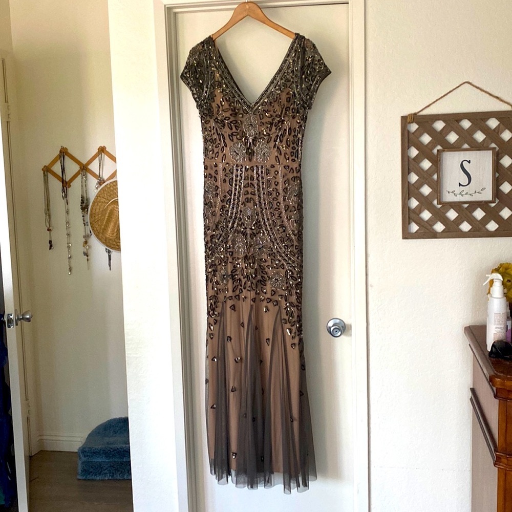Size 10 on altered, David’s bridal gown. Worn once. Kind of a taupe color.